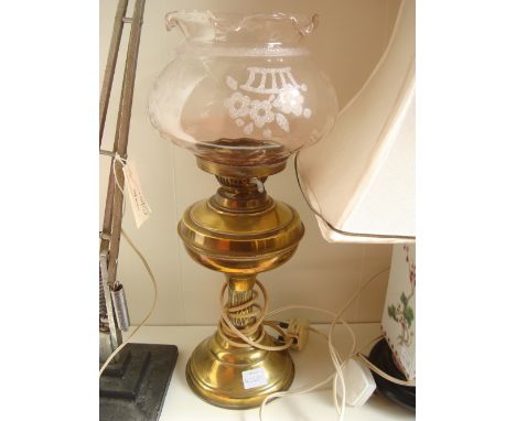 An Edwardian gilt brass oil lamp with glass shade fitted for electricity. 