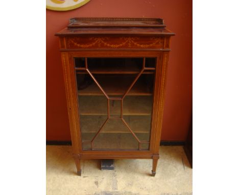 A late Victorian mahogany sheet music cabinet, the satinwood crossbanded top above a frieze inlaid with marquetry ribbon tied