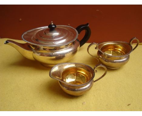 A George V silver three piece tea service, London, 1927 by The Goldsmiths & Silversmiths Co Ltd.  Of circular bellied form wi