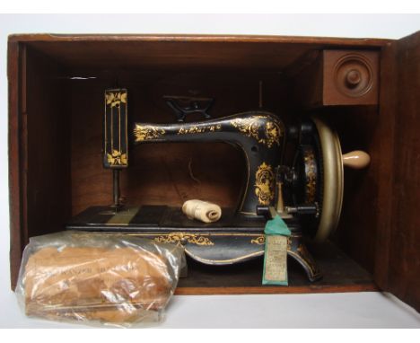 A late 19th Century Wanzer 'B' sewing machine, Patented 1883, manufactured in Canada; gilt floral decorated black painted cas