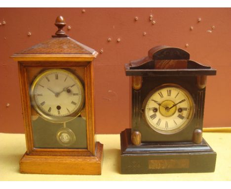 A German one day Japanned mantle clock and an oak cased mantle clock. 