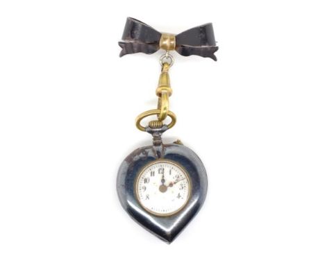 Antique heart brooch fob watch in gun metal and gilt metal highlights. With a stem wind mechanical movement. Approx height of