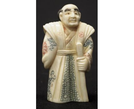 Early carved Ivory sage holding a stick figure C1920, signed to base, height 7.5cm approx. NB.This item cannot be exported.