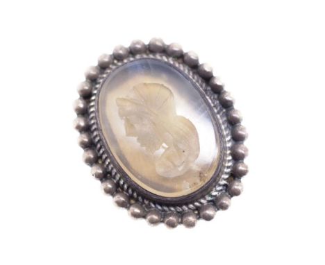 Carved Intaglio and silver ring attributed to Jan Logan. With a carved profile of Hellenistic soldier. Unmarked. Approx 15mm 