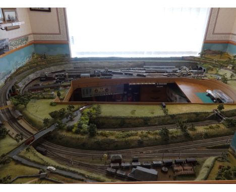 An assembled N gauge model railway layout and rolling stock, The 00 models, shown in the cabinet are scratch built not workin