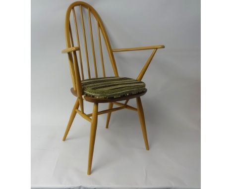 Ercol, a light elm dining table and chairs comprising a pair of carvers, four standards, dining table with two extension leav