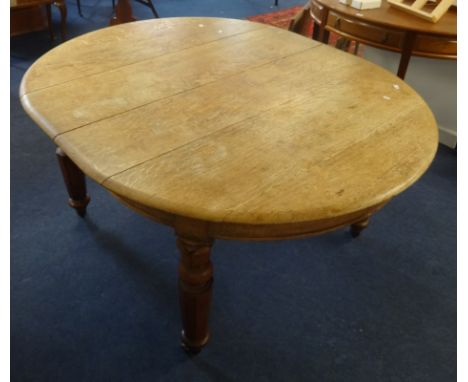 A Victorian light oak dining table with extending movement to accommodate five small size leaves, overall length approx 302cm
