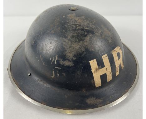 A British Home Front MkII WWII steel helmet painted black and labelled in white HR for Heavy Rescue. Helmet stamped JSS 1939,