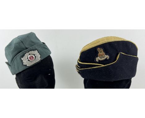 2 vintage military side caps with badges. A green canvas Cold War style Volkspolizei cap with badge together with a black fel