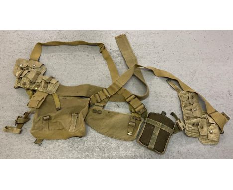 A quantity of WWII era tan coloured canvas webbing, with bag, pouches and water bottle. Stamped with War dept arrow mark and 