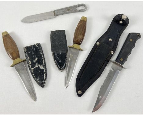 A collection of 4 military and survival knives. To include U.S. Military mess knife and a survival knife by Tramontina with c