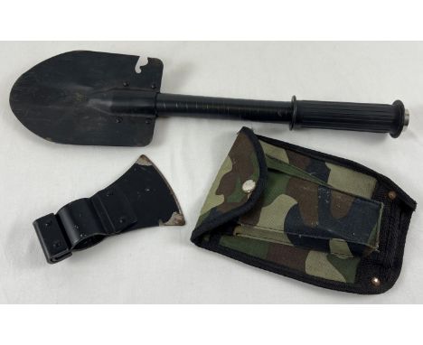 A modern military style shovel tool with axe head attachment and camo design case. 