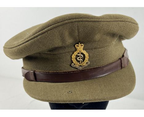 A WWI style British Army peaked hat with Medical Corps cap badge and leather strap. 