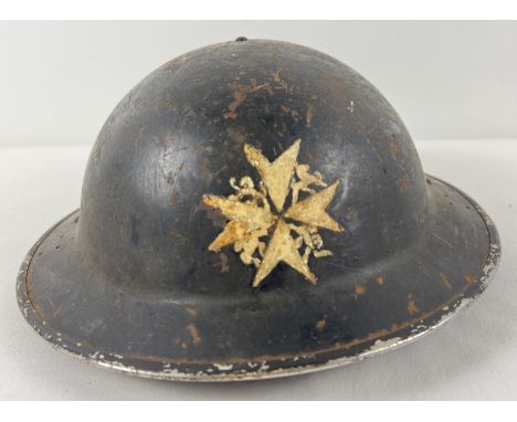 A WWII British Home Front MkII No.2C steel helmet with early oval pad. Painted black with St. John Ambulance Brigade badge pa