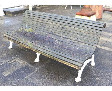 A Victorian Cast Iron Garden Bench, late 19th/early 20th century, of S-shape form, with three later painted tree branch suppo