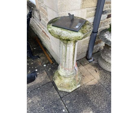 A Composition Circular Column Garden Pedestal, 20th century, the top mounted with a modern engraved metal sundial, the circul