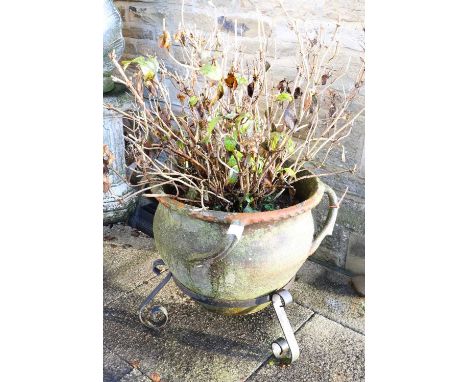 A 20th Century Cauldron-Shape Terracotta Planter, with four moulded handles, on a scrolled wrought iron base62cm by 55cm