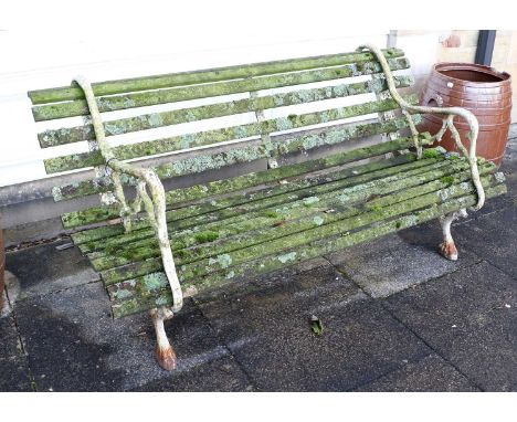 A Victorian Cast Iron Garden Bench, late 19th century, the painted end supports as tree branches with claw feet supporting fo