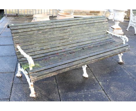 A Victorian Cast Iron and Later Painted Garden Bench, late 19th century, of curved form, the end supports modelled as tree br