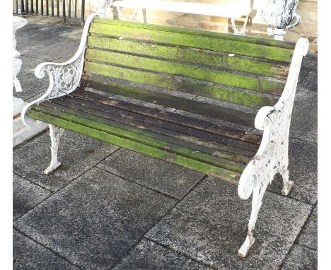 A Victorian Cast Iron and Later Painted Garden Bench, late 19th century, the scrolled end supports with guilloche-pattern bor