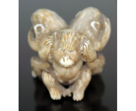 A Japanese carved ivory netsuke depicting The Three Wise Monkeys, signed Masatomo, height 32mm.  Condition - the See No Evil 