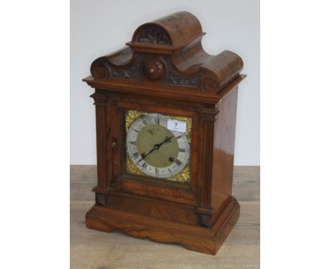 A late 19th century architectural walnut mantel clock with brass and silvered dial, twin spring driven movement striking on d
