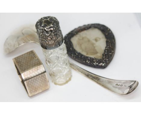 A mixed lot of hallmarked silver comprising a ladle length 18cm, a serviette ring, a scent bottle and a photograph frame.  