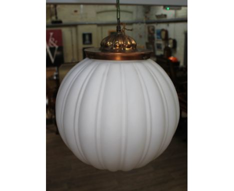 An early 20th century milk glass light fitting of spherical globe form with gilt brass fitting, diam. approx. 40cm.&nbsp;Cond