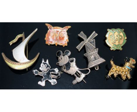 Assorted brooches and badges including a Felix the Cat brooch by Charles Horner, a Norwegian silver gilt and enamel viking sh