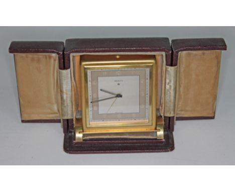 An Art Deco Zenith alarm clock in leather case, height 11.5cm.  