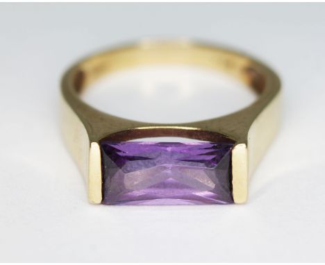 A Modernist amethyst ring. indistinctly marked '585', gross wt. 5.20g, size R.  Condition - good, minor nibbles to girdle, ge