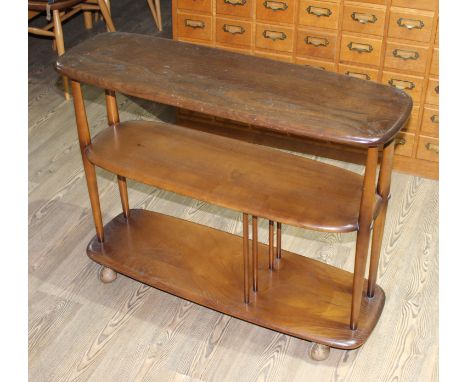 An Ercol dark elm 'Baby Giraffe' bookcase trolley.&nbsp;Condition - general wear including dings, surface marks, slight fadin