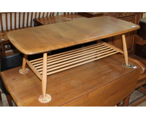 An Ercol light elm and beech coffee table.Condition- some wear to the finish and slight splitting to the top.