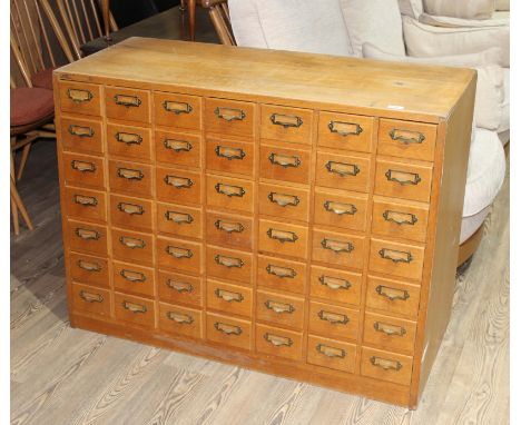 A light oak cabinet of 49 file drawers, 20th century, width 114cm, depth 47cm & height 85cm.Condition- some general wear to i