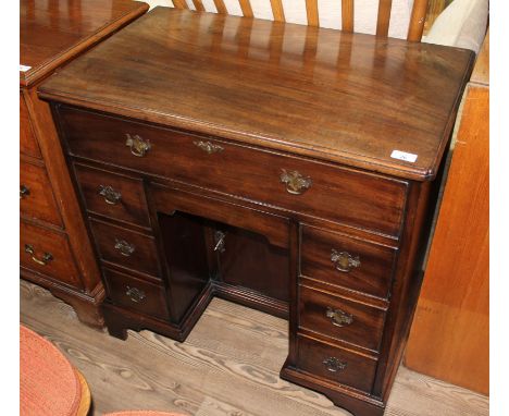 A reproduction mahogany Georgian style knee hole desk, mid 20th century, the top drawer wfitted with compartments and fold ou