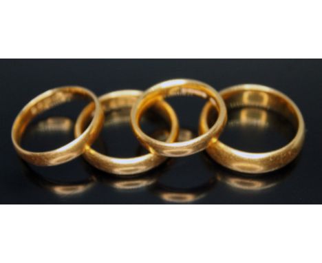 A group of four hallmarked 22ct gold wedding bands, wt. 24.55g, sizes K, N &amp; P.  