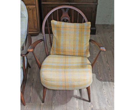 A vintage Ercol dark elm 'Fleur de Lys' armchair.  Condition- some wear to the finish, mostly to the arms.