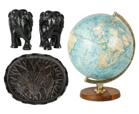 A mid-century globe. With silvered metal mount and teak base, height 39cm. Together with a pair of carved ebony elephants and