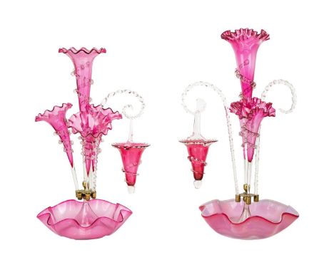 A Victorian cranberry glass part epergne. Height 50cm together with another smaller cranberry part epergne.