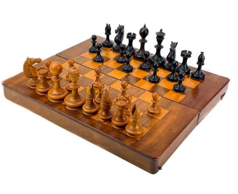 An ebony and boxwood Staunton pattern chess set.  Height of king 8.5cm, together with a folding chess board box, 32cm x 37cm 