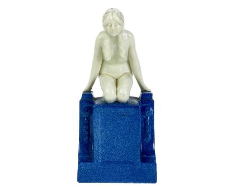 An Art Deco Royal Worcester figure of a Naiad. The figure modelled kneeling on a powder blue decorated pedestal, printed mark