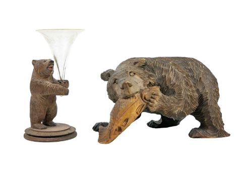 A Black Forest type carved wood sculpture of a bear with a salmon. Height 12cm. Together with a posy vase in the form of a ca