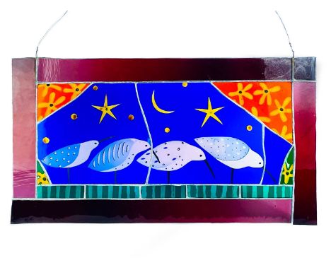 A contemporary stained glass panel.  Decorated with four birds beneath the moon and stars, within a ruby red border. Height 3