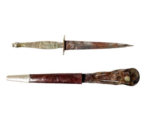 A Fairbairn Sykes first pattern fighting knife. With chequered handle grip slight 'S' oval hilt with leather scabbard and met