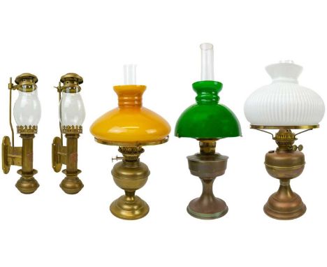A Victorian brass oil lamp with green shade. Height 60cm, together with two other brass oil lamps and a pair of reproduction 