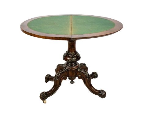 A Victorian burr walnut half round fold top card table. With a baized interior, on a turned and carved pillar and quatreform 