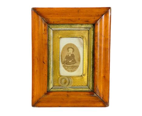 A Victorian child portrait with first lock of hair. Frame size 21cm x 17cm.