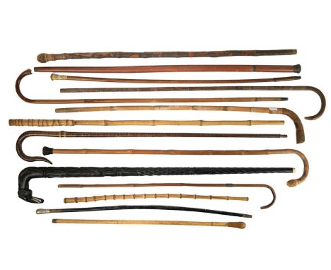 A selection of walking sticks and canes. Including a Duke of Wellington swagger stick, a gilt mounted cane, Oriental carved b