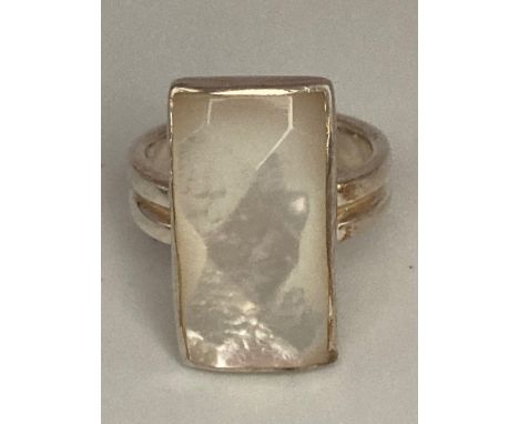 SILVER RING having faceted mother of pearl stone set to top in rectangular mount. Presented in original retail box.Size K 1/2