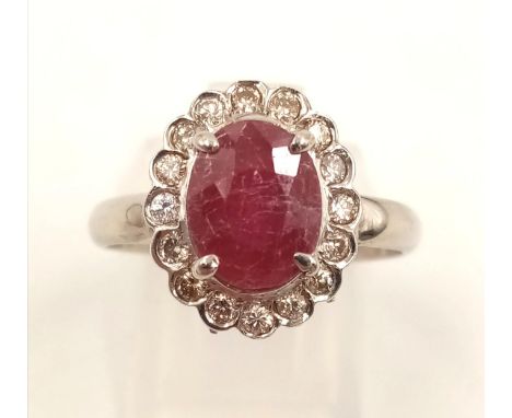 A 14K White Gold Ruby and Diamond Ring. Ruby - 2.3ct centre stone surrounded by 0.35ct halo of diamonds.Size P. 4.28g 
